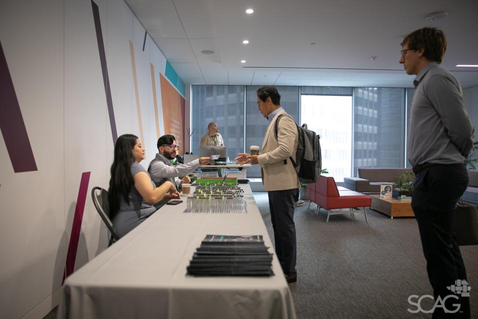 Workshop attendees check in at the registration table in the SCAG main office.