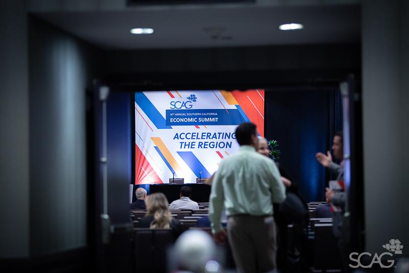 An Economic Summit attendee standing in a doorway.