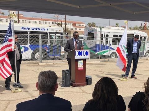 SCAG Executive Director Kome Ajise delivers remarks at a podium outside the groundbreaking event.