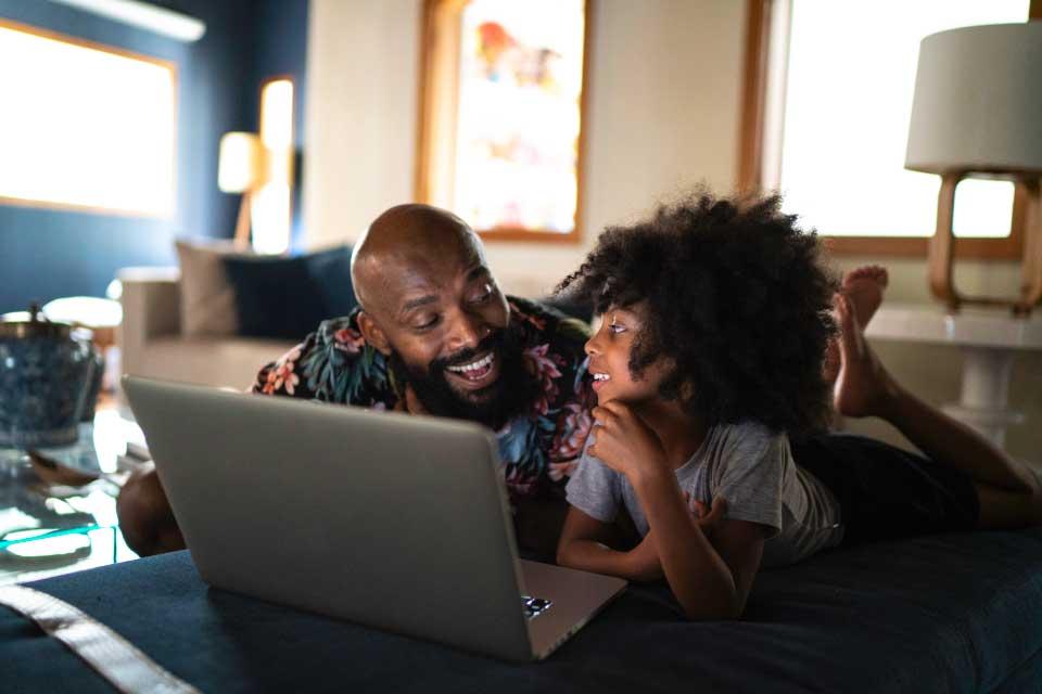 Father and small child in front of a computer at home