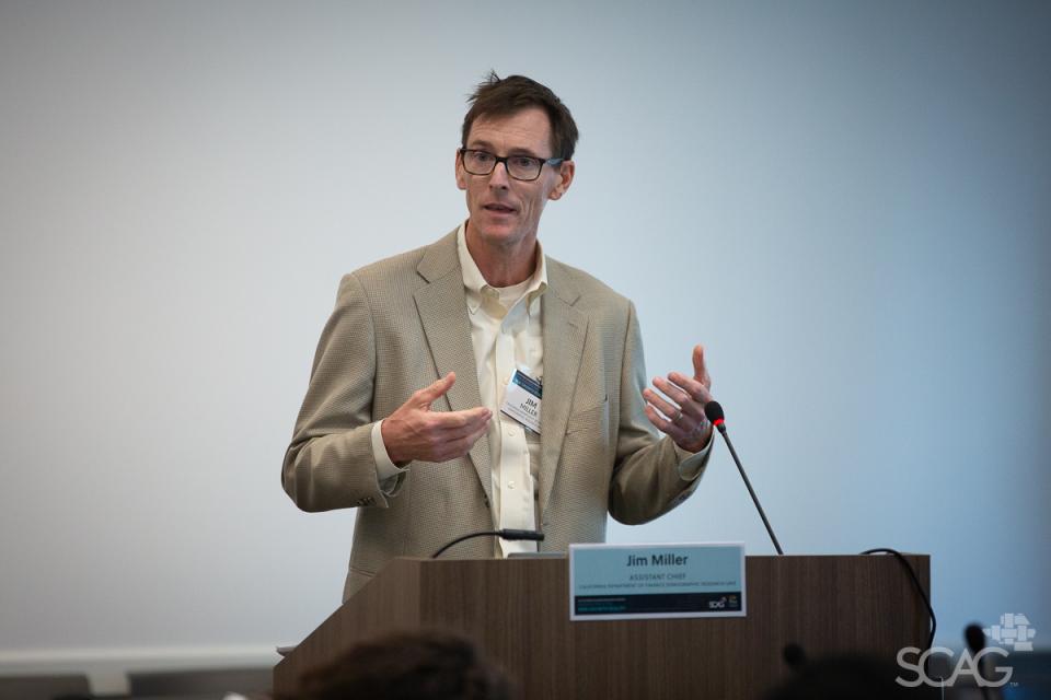 Roundtable discussion presenter at a podium during the 2024 Southern California Demographic Workshop.